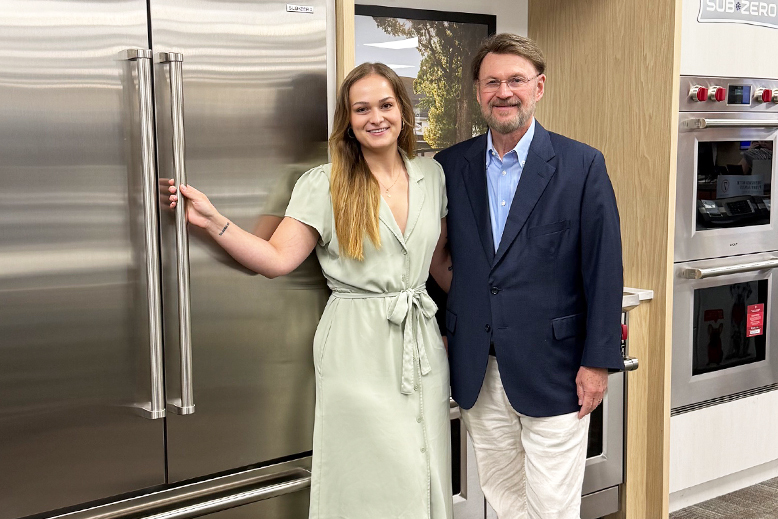 John Cioletti, President & CEO of Reno’s Appliance (right), with his daughter, Jessica, the third generation to work at Reno’s, with the SubZero French Door refrigerator.