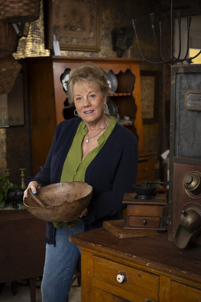 Kim Ferruggia, co-owner of the Carriage House in Lafayette, NJ, shows off a pre-Revolution, Native American elm bowl.
