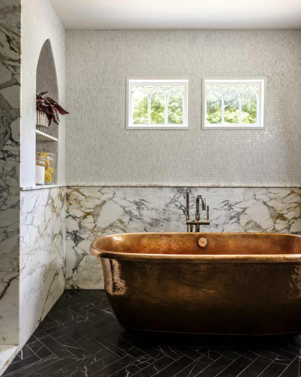 A hammered-copper tub in a Summit home's primary bathroom