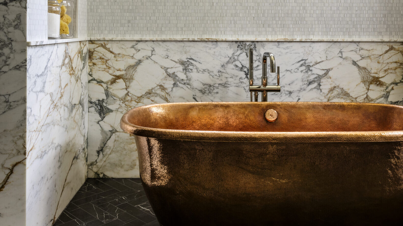 A hammered-copper tub in a Summit home's primary bathroom