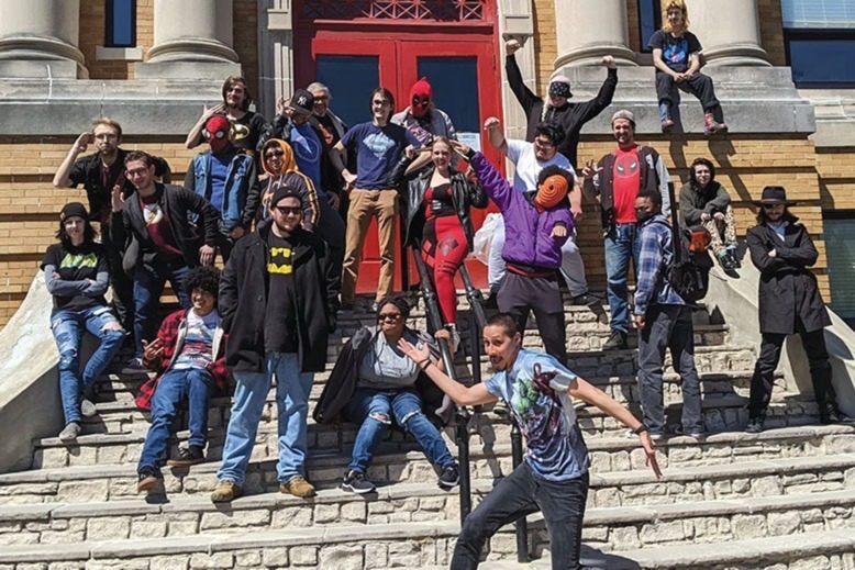 Students on the steps of the Kubert School in Dover, celebrating National Superhero Day