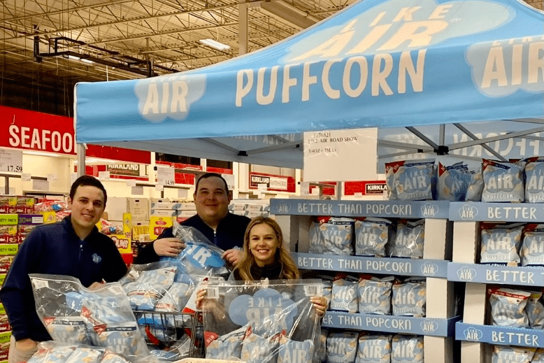 Siblings Kevin Atieh, Steve Atieh and Allison Lin in a grocery store with their product, Like Air Baked Puffcorn