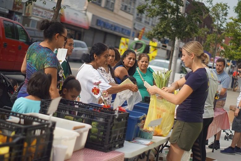 People shopping for produce at an outdoor market