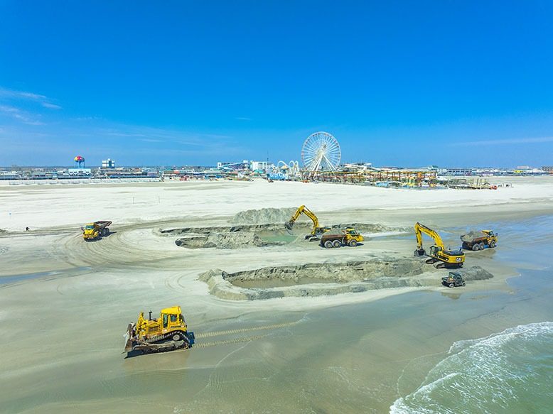Trucks dig up sand in Wildwood to transport to North Wildwood