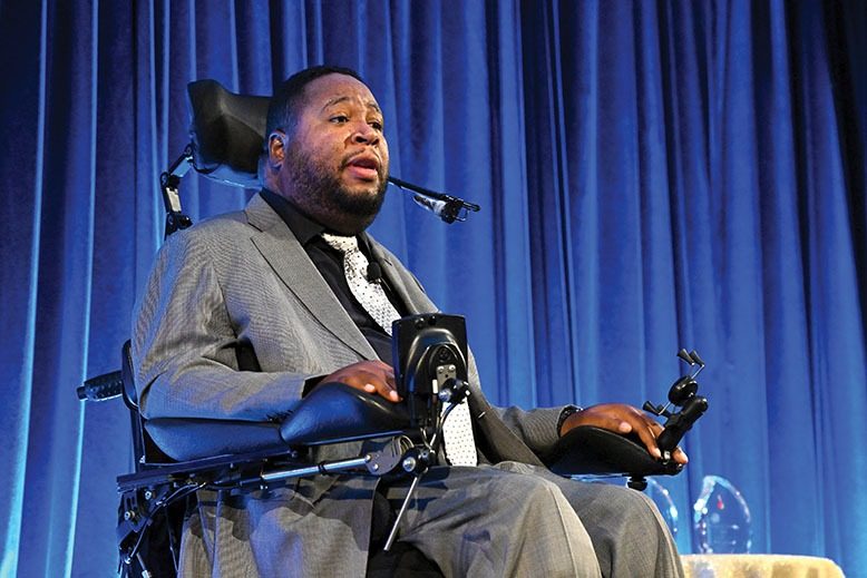 Eric LeGrand speaks at a 2022 event for the Christopher & Dana Reeve Foundation