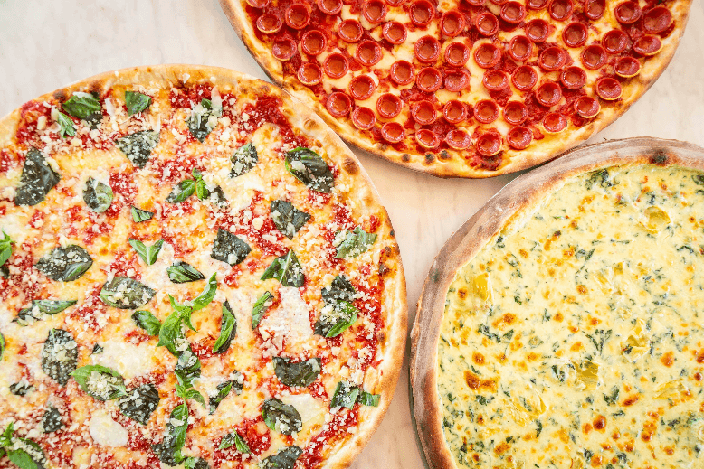 A pepperoni pizza, an artichoke pizza, and a cheese pizza with fresh basil.