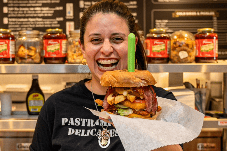 Monica Fabara serves up Pastrami House Delicatessen’s fat burger