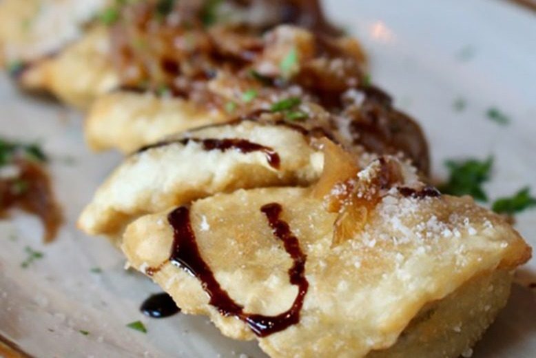 A photo of fried peirogies on a plate