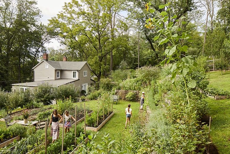 Nancy Kay Anderson gardening on her Lambertville property with daughter and granddaughters