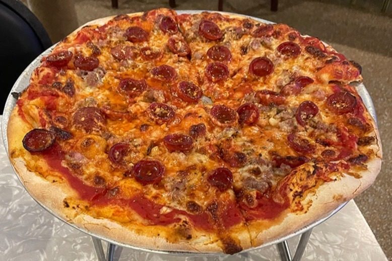 A pizza pie topped with sausage and pepperoni at Conte's Pizza and Bar in Princeton
