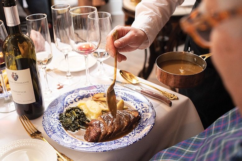 Ordering the duck entrée means a dramatic tableside experience.