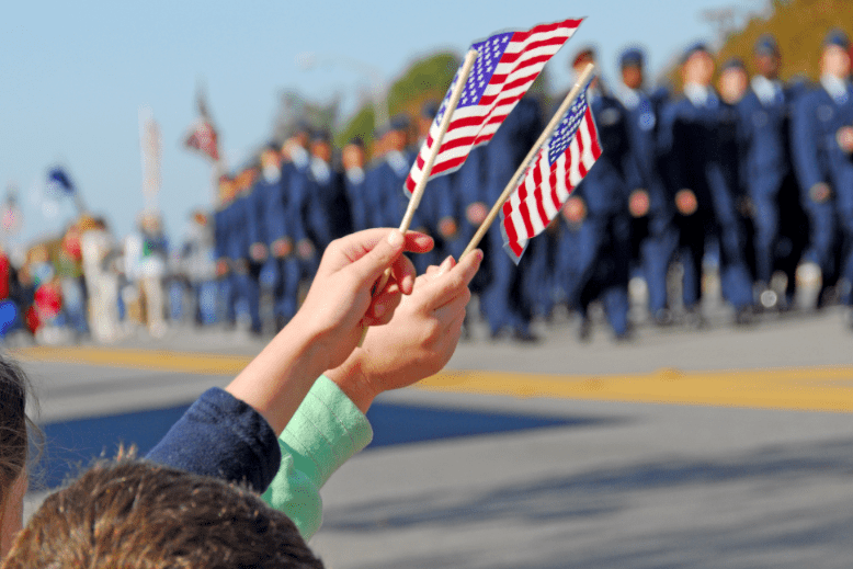 Parade with children waving American flags