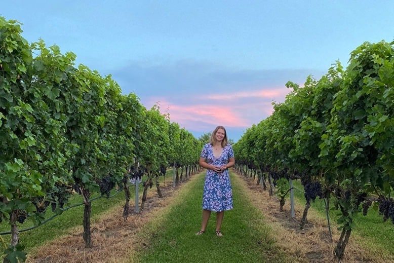 Victoria Reader, founder of New Jersey Women in Wine, stands in a Salem County vineyard at sunset
