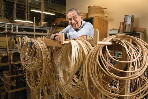 Shop manager Al Kessler looks over a rack of bamboo strips that will be used for caning.