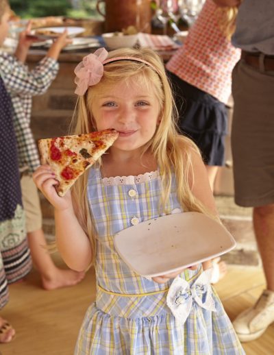 Juliana nibbles a slice.