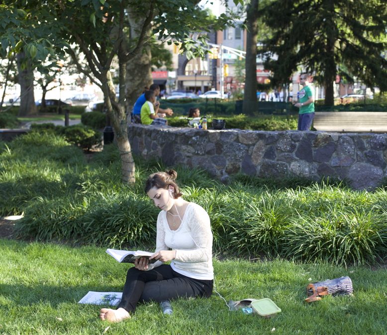 A resident reads on the Morristown Green.
