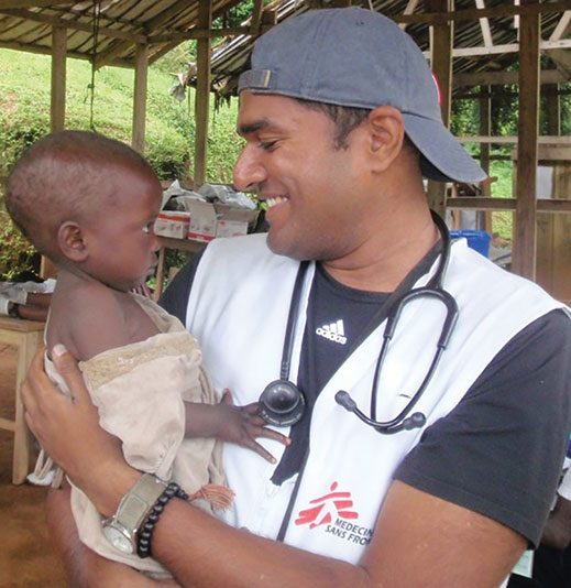 Nurse Saman Perera comforts a toddler in Congo.
