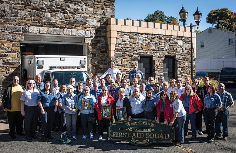 After the volunteer West Orange First Aid Squad was disbanded, its members from over the years gathered for a memorial photograph in front of the squad's castle-like headquarters.