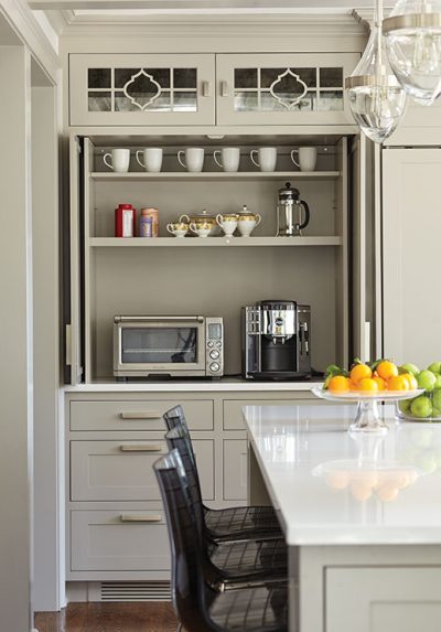 The breakfast bar, outfitted with LED lighting and electrical outlets, is concealed behind pocket doors.