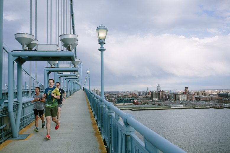 Runners cross the Ben Franklin Bridge from Camden to Philadelphia.