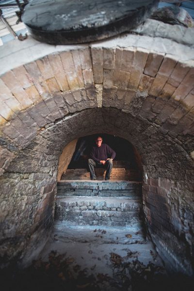 Bruce Dehnert, head of ceramics at Peters Valley, sits inside the craft school's 46-foot-long Anagama kiln.