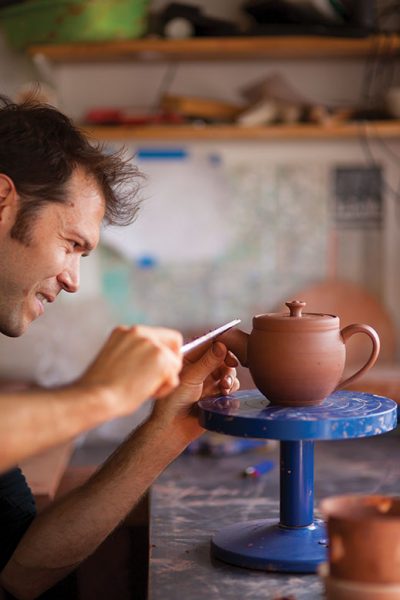 Jono Pandolfi, in his Union City studio, crafts stoneware teapots, plates and bowls for fine restaurants.