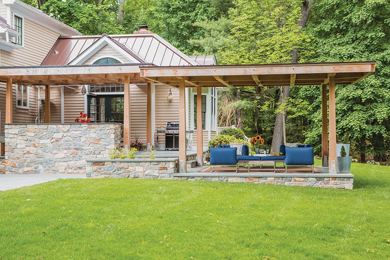 Susannah and Michael Sung's two-tiered patio provides not only shade, but energy savings. The lower-level patio, in a contemporary palette of blue and charcoal, is the hangout space. The structure's frame is made of insect-resistant Western red cedar.