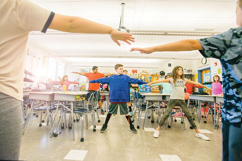 A fifth-grade class at Woodland Elementary School in Monroe Township takes time out for a midday yoga session.