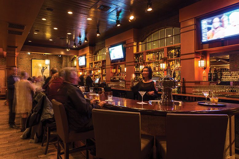 Some Chop House patrons gravitate to the main bar (bartender Heather Neborak on duty).