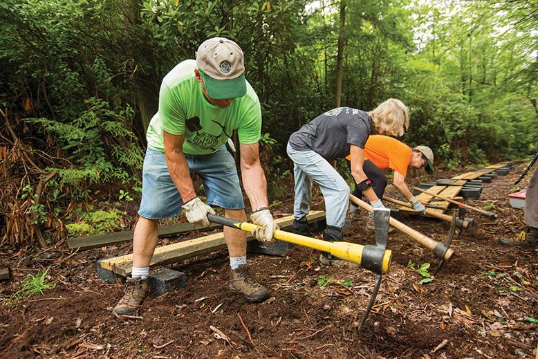 Trail Conference volunteers, from left, James Mott, Linda Taggart and Jean Brennan dig beds for an elevated path through Wawayanda State Park.