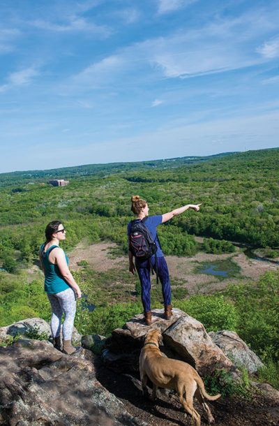 Reporter Joanna Buffum, right, points west toward Hackettstown from the heights of the Highland Trail through Allamuchy State Park.