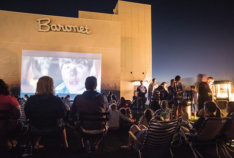 Movie fans get cozy at an outdoor screening of the 1985 comedy The Goonies on the Asbury Hotel's rooftop deck.