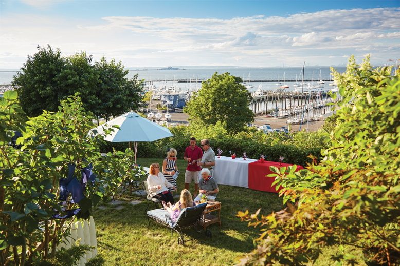 party planner Hostess extraordinaire Leeann Lavin (in stripes), together with her husband Bill, host an all-day Fourth of July party for friends and family in their gently sloping Atlantic Highlands backyard.