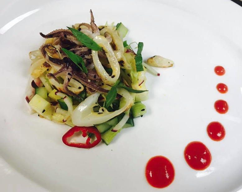 Spicy squid salad with pineapple, cucumber and chili.
