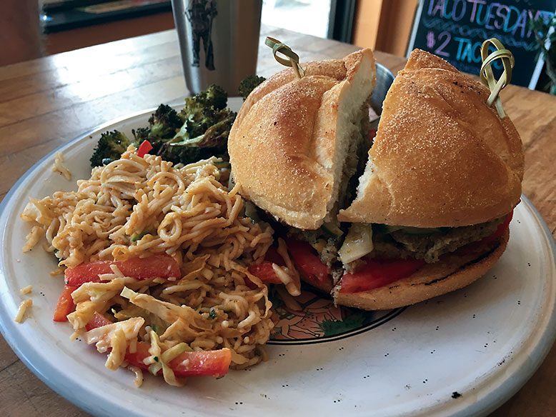 The falafel, a chickpea patty with greens, pickles and Greek yogurt spread (pictured, with side of cold ramen salad).