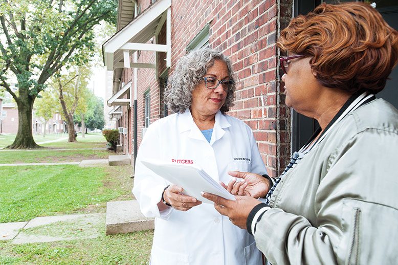 Nurse practitioner Darcel Reyes, left, confers with community health worker Barbara Robinson at Stephen Crane Village, an affordable housing community in Newark.