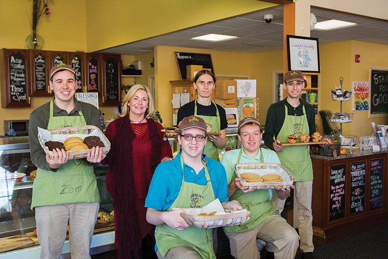 Karen Monroy with members of the Grateful Bites team, from left, Zack, Nate, Eric, Mike and Harry. The bakery is staffed by young adults with developmental disabilities.