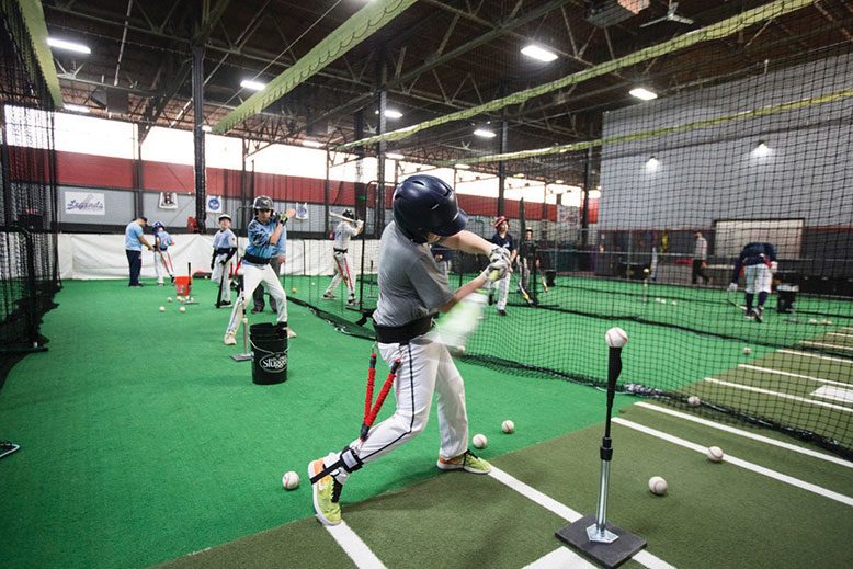Members of the New Jersey Nationals, a North Caldwell-based club team, practice hitting off a tee during winter workouts at 360 Fitness, an indoor facility in Fairfield.