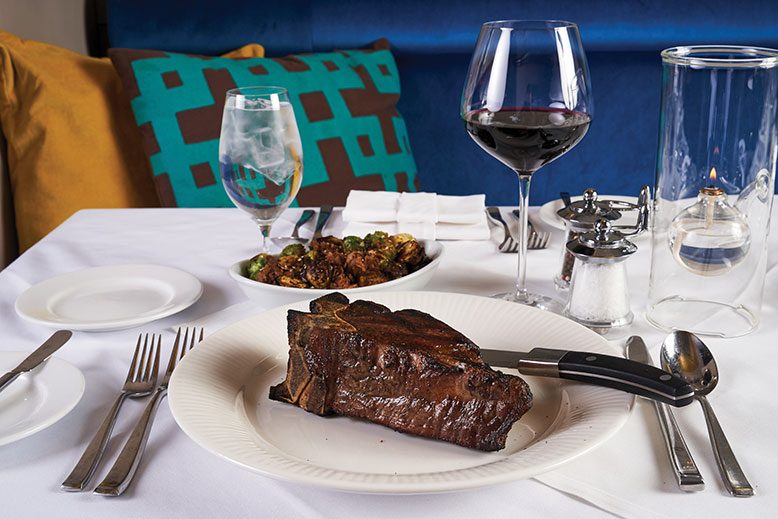 The big filet mignon, served (as few are)on the bone, with Brussels sprouts in the background.