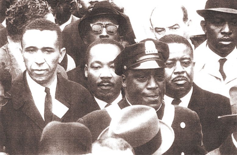 The Reverend Gilbert H. Caldwell joined Dr. Martin Luther King Jr. at a rally in Boston, April 1965.