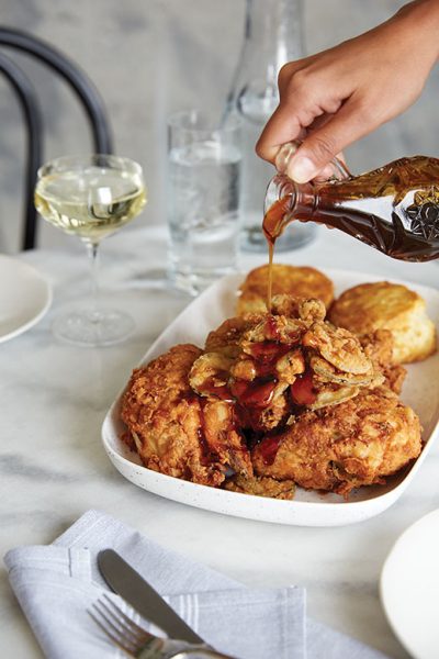 Drizzling chili-steeped honey over fried smoked chicken and biscuits.