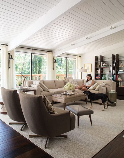 Kathy and Luis Pereira’s daughter, Sara, and the family’s rescue dog Reis (queen in Portuguese) enjoy the light and airy living room in their Tewksbury home.
