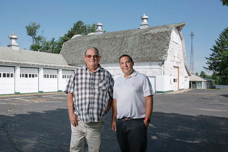 Harold "Skeeter" Heritage and his son, Harold "Skeeter" Heritage Jr. in front of the old dairy barn.