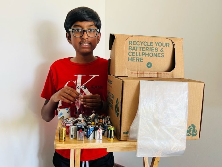 Sri Nihal Tammana poses with a recycling box for an assortment of used batteries