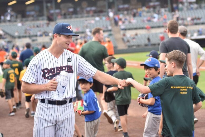 Somerset Patriots pitcher Sean Boyle connects with a young fan at the stadium